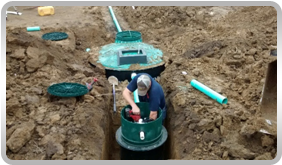 Picture of man working on installing a new sewer line
